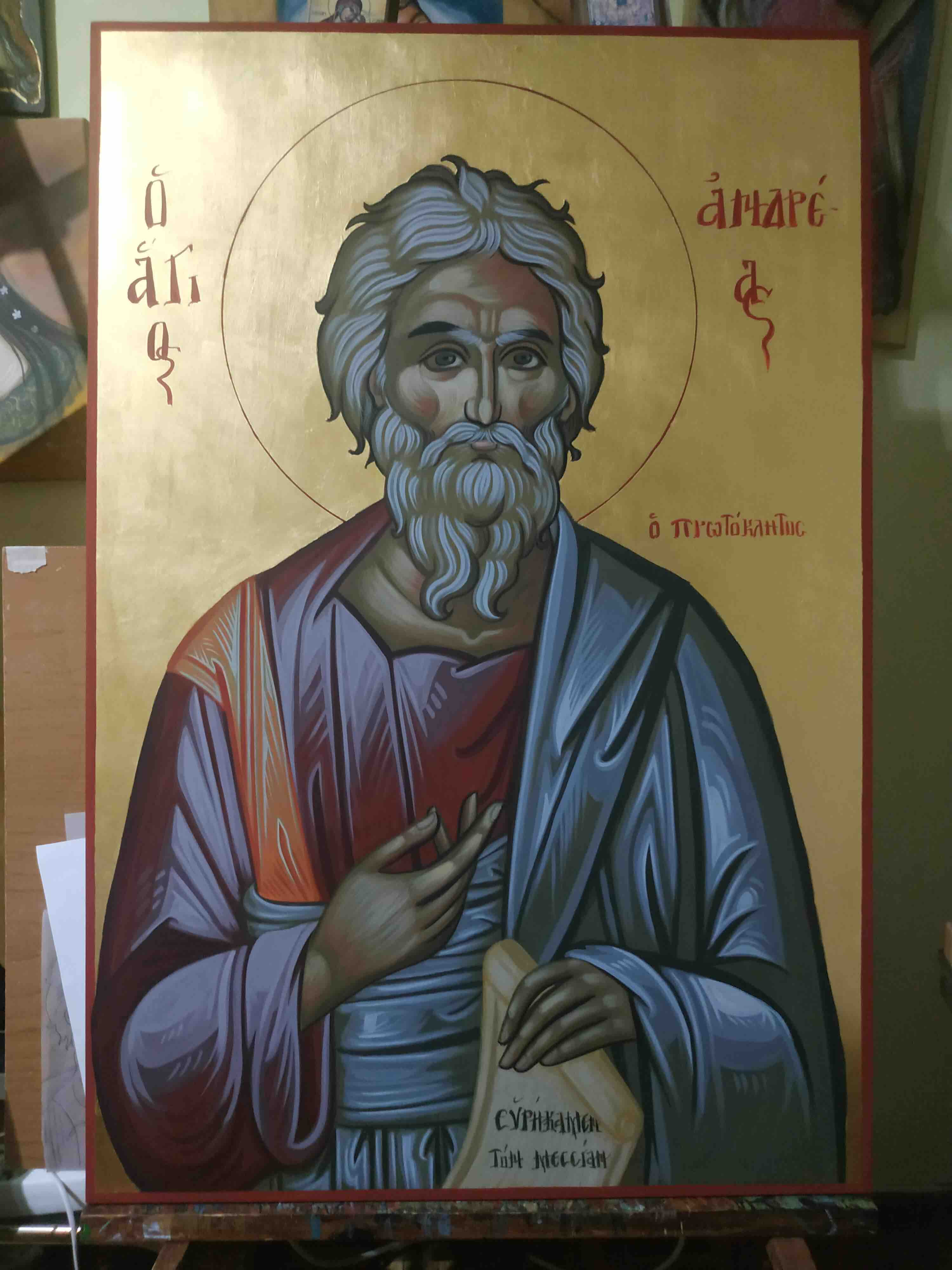 Byzantine Icon of Saint Andrew looking at the viwer, making a delicated gesture with his right hand, while holding a papyrus with lef hand