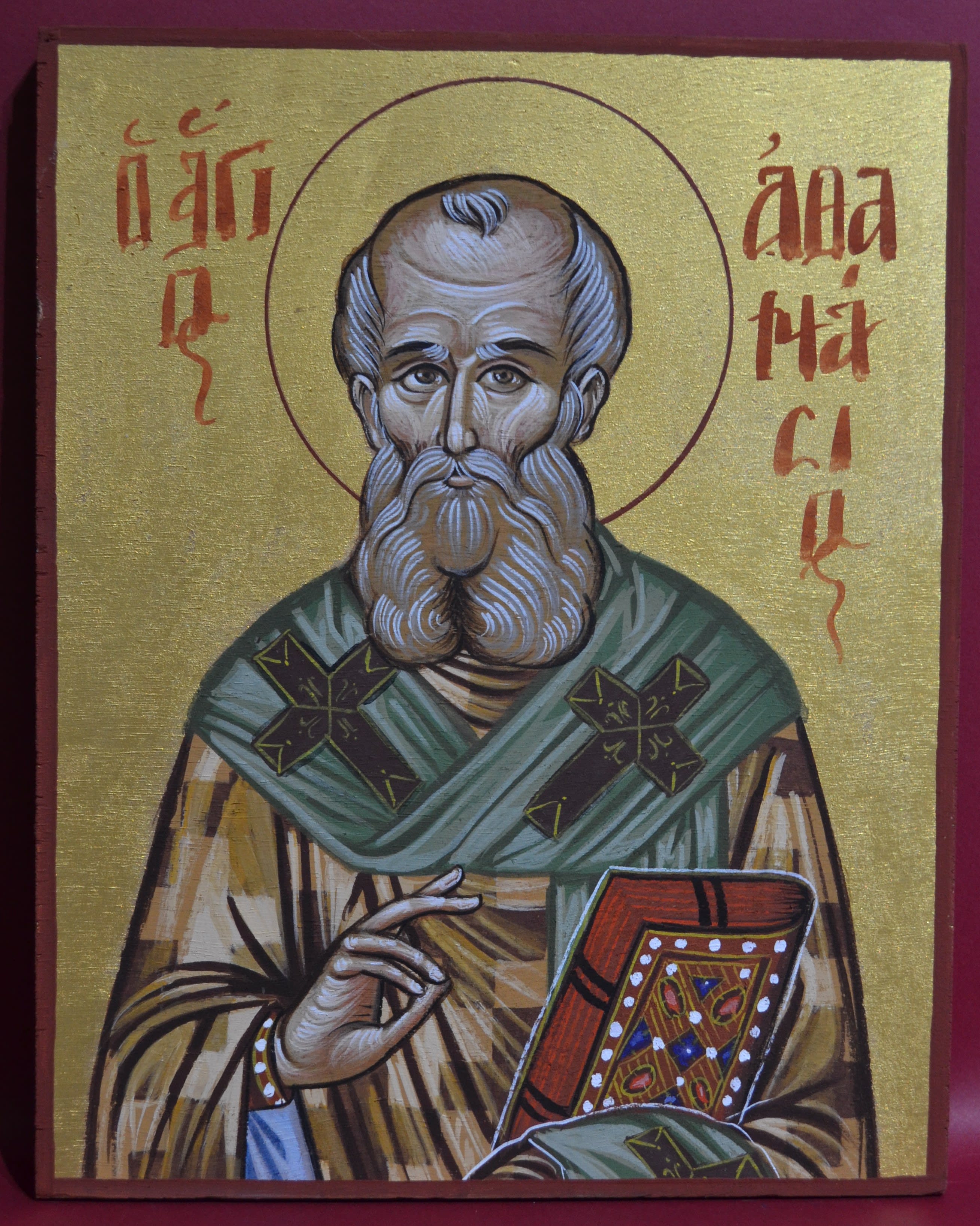 Byzantine painting of Saint Athanasius blessing everyone, holding a holy book in his left hand, while dressed lavishly