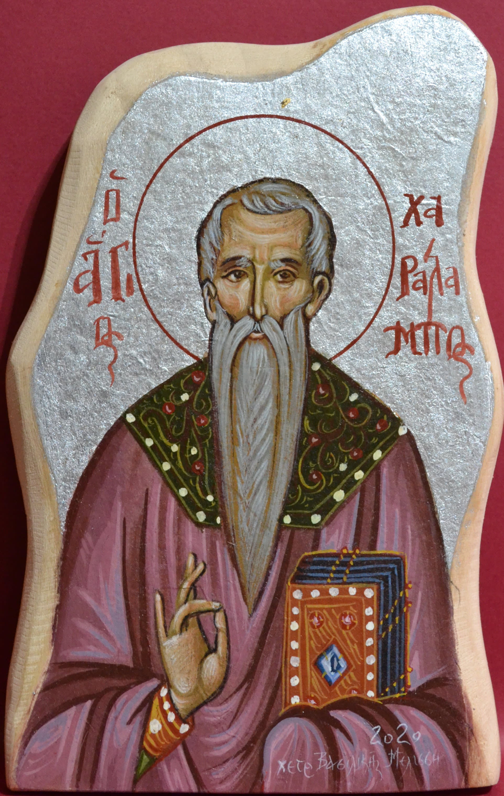 Hagiography of Saint Charalampos, blessing everyone with his right hand while dressed lavishly and holding a holybook in his left hand