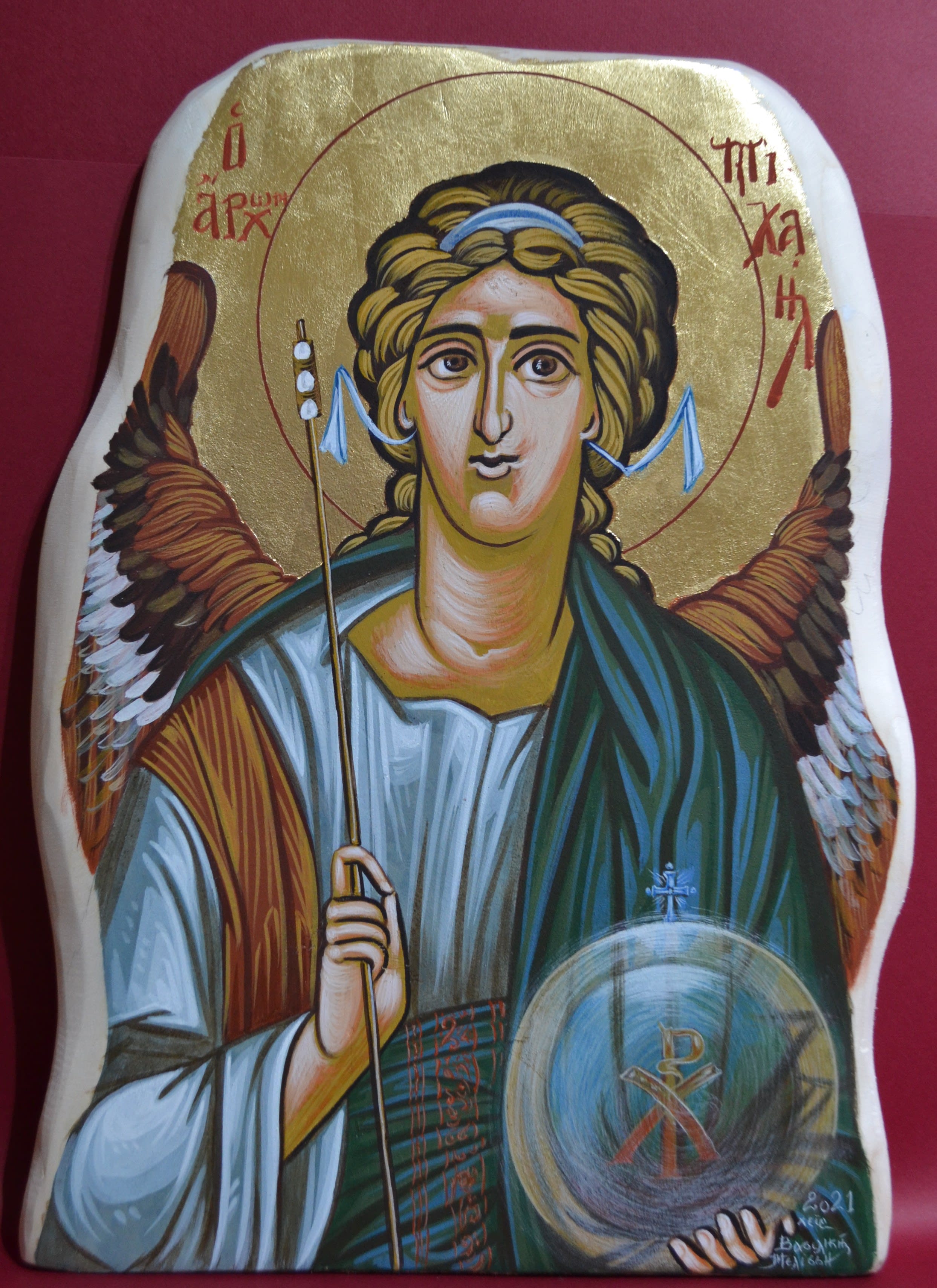 Archangel Michael holding a scepter in his right hand and an ethereal sphere in his left hand